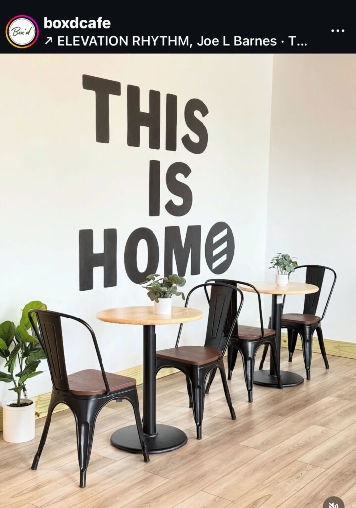 Interior of a cafe owned by a right wing church with a decoration that is meant to say "THIS IS HOME" but accidentally reads as "THIS IS HOMO."